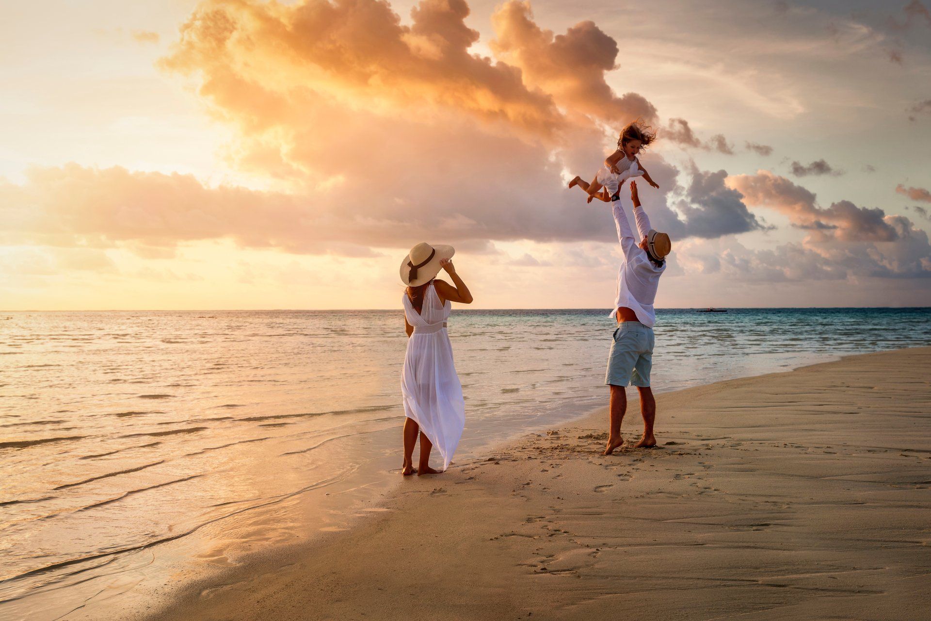 Family enjoying a warm sunset on the beach