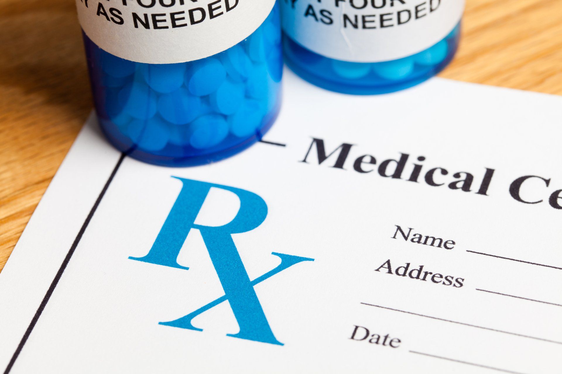 Labeled medication bottles and a prescription